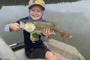 Boy holding largemouth bass