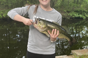Young woman holding a big largemouth