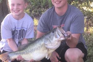 two boys holding bass