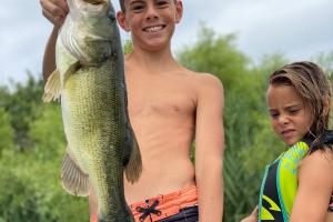 Boy holding largemouth bass