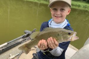 Boy angler holding fish