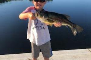 Young boy holding bass