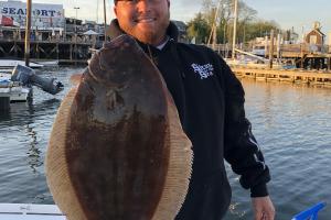 Angler hold up flounder