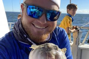 Angler holding pufferfish