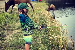 Young angler fishing with elk 