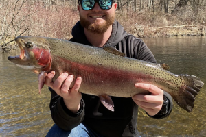 Angler holding cutthroat trout