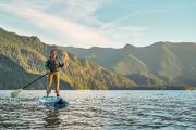Woman Paddle Boarding on a lake