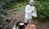 Angler frying fish on shore